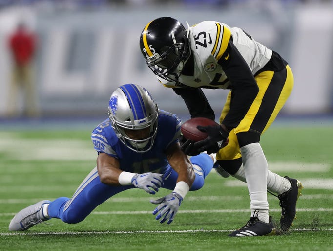 Lions wide receiver Golden Tate fumbles the ball away