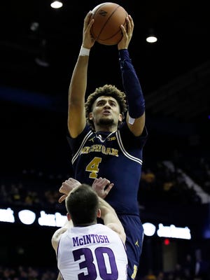 Michigan Wolverines forward Isaiah Livers (4) goes to the basket against Northwestern Wildcats guard Bryant McIntosh (30) during the first half at Allstate Arena, Tuesday, Feb. 6, 2018.