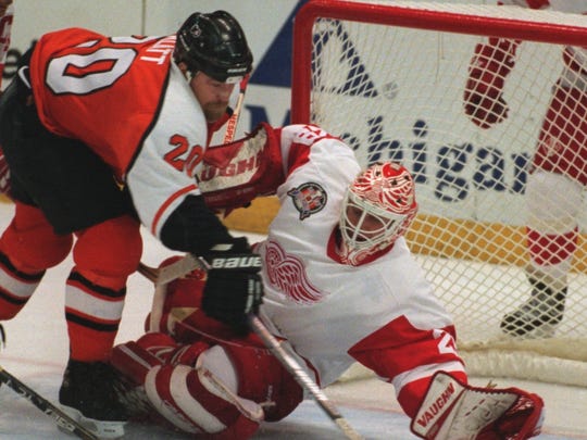 Mike Vernon makes a save against the Flyers' Trent Klatt in Game 4 of the Stanley Cup finals June 7, 1997.