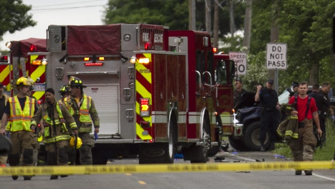 Police and rescue workers attend to the scene after multiple bicyclists were struck by a vehicle in a deadly crash Tuesday in Copper Township near Kalamazoo.