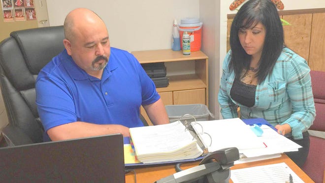 Silver City Police Department Captain Javier Hernandez, left, looks at some files along with detective Melinda Hobbs. The duo solved a cold case file last week and are actively investigating another cold case. Hobbs was the Silver City Police Department Officer of the Year last year.