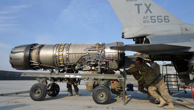 Airmen assigned to the 455th Expeditionary Aircraft Maintenance Squadron remove the engine from an F-16 Fighting Falcon Jan. 22, 2014, at Bagram Airfield, Afghanistan.