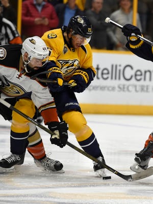Ducks center Nate Thompson (44) and Predators center Craig Smith (15) battle for the puck during the first period Tuesday.