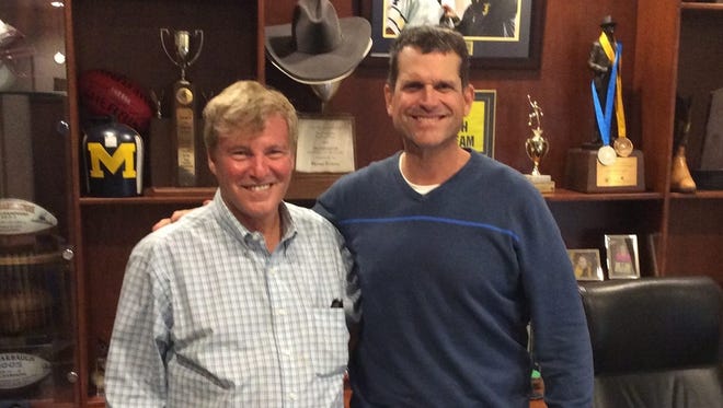 Jim Harbaugh, right, with Leigh Steinberg.