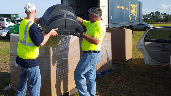 Workers load an old television at last year’s residential recycling event, where over 16,500 pounds of electronic waste were collected and safely recycled.