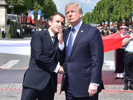 French President Emmanuel Macron shakes hands with