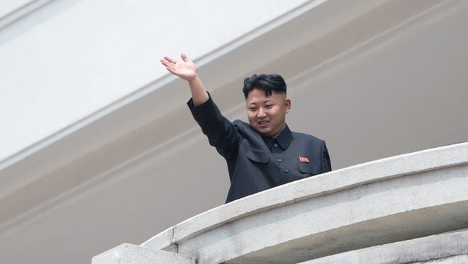 North Korean leader Kim Jong-Un waves to the crowd during a military parade at Kim Il-Sung square marking the 60th anniversary of the Korean war armistice in Pyongyang on July 27, 2013. North Korea mounted its largest ever military parade on July 27 to mark the 60th anniversary of the armistice that ended fighting in the Korean War, displaying its long-range missiles at a ceremony presided over by leader Kim Jong-Un.