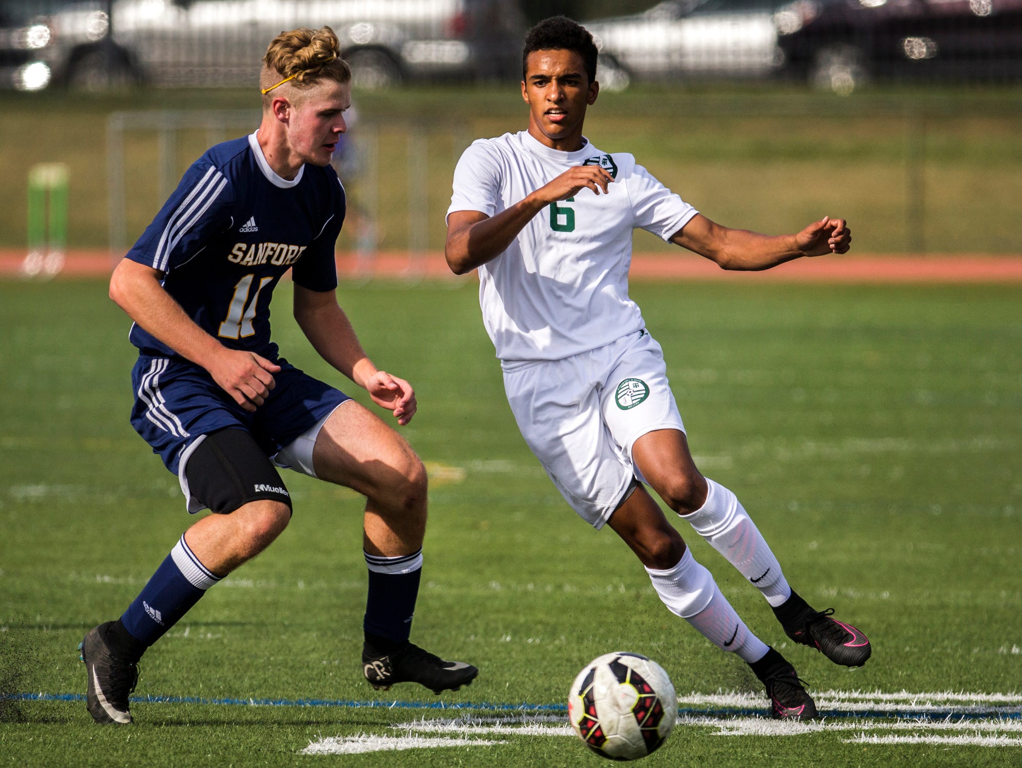 Tower Hill's Malcolm Johnson (No. 6) cuts past Sanford's Robert Stafford (No. 11) in the first half of Tower Hill's 3-1 win over Sanford at Tower Hill School in Wilmington on Wednesday afternoon.