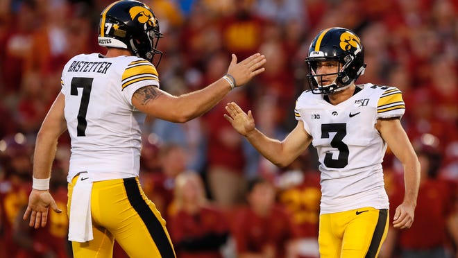 FILE - In this Sept. 14, 2019, file photo, Iowa's Keith Duncan (3) celebrates with Colten Rastetter, left, after kicking a field goal during the first half of an NCAA college football game against Iowa State, in Ames, Iowa. Duncan was a freshman hero _ only to lose his job for two full seasons. He's re-emerged as a key cog for the 14th-ranked Hawkeyes in 2019. (AP Photo/Charlie Neibergall, File)
