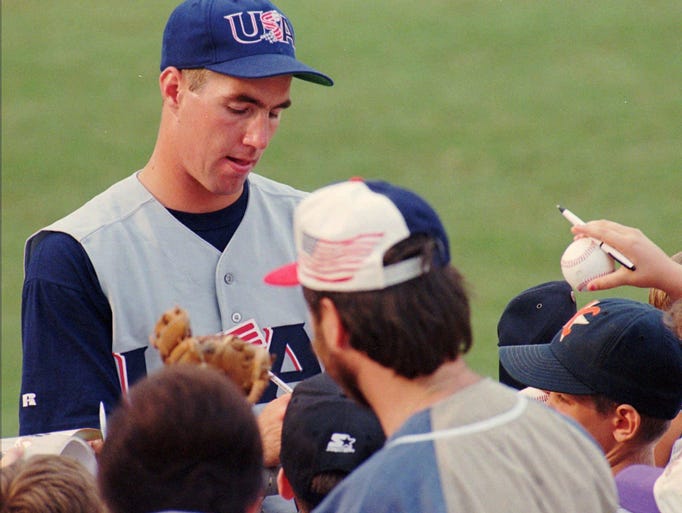 R.A. Dickey, with Team USA, signs autographs before