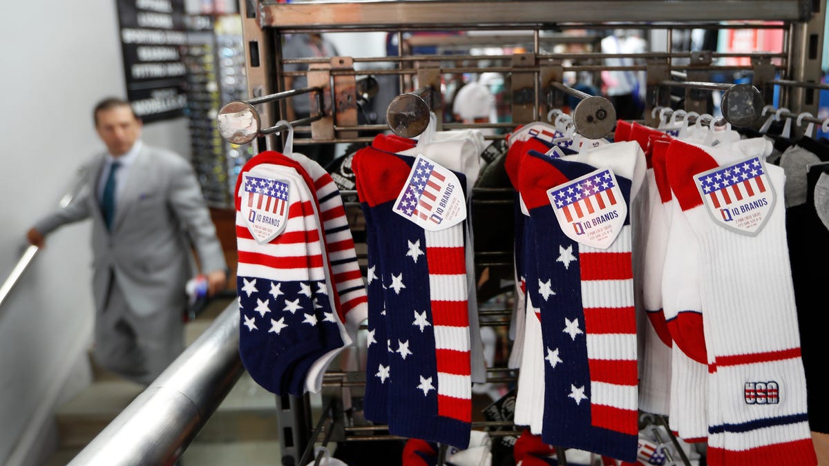 Red, white and blue socks are prominently displayed in an athletic clothing store one day ahead of a ticker-tape parade for the U.S. Women's Soccer World Cup winning team, Tuesday, July 9, 2019, in New York. (AP Photo/Kathy Willens)