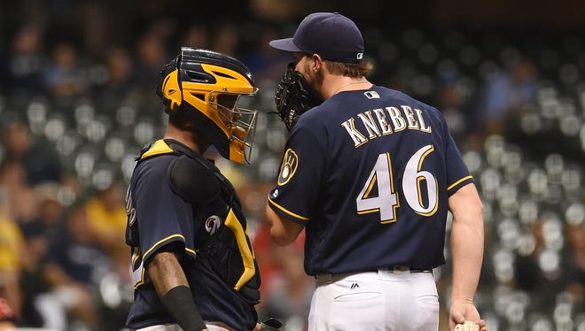 Catcher Martin Maldonado speaks with Corey Knebel during the 10th inning of Tuesday's game.