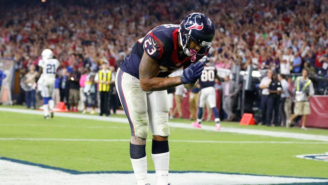 Houston Texans running back Arian Foster (23) bows to celebrates his third quarter touchdown against the Indianapolis Colts at NRG Stadium.