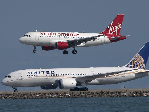 A Virgin America craft lands within perspective of a United