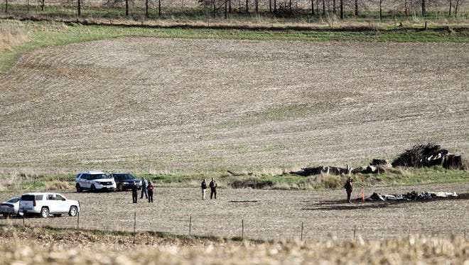 Local law enforcement investigate a plane crash at an Oxford cornfield on Friday, April 7, 2017.