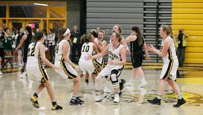 Cascade girls basketball celebrates their 41-39 win in a semifinal game against North Marion on Friday, March 9, 2018, at Forest Grove High School.