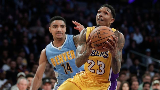 Los Angeles Lakers guard Lou Williams drives to the basket past the Denver Nuggets' Gary Harris on Jan. 31, 2017, in Los Angeles.