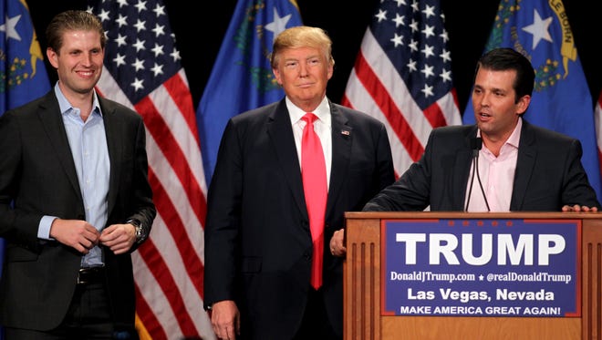 Donald Trump Jr., right, with his father, Republican presidential candidate Donald Trump, center, and his brother, Eric Trump, left, during a campaign rally on Thursday, Jan. 21, 2016, in Las Vegas.