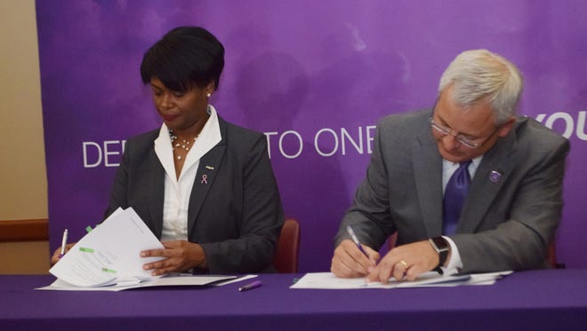 Joan Y. Davis (left), chancellor of Delgado Community College in New Orleans, and Jim Henderson, president of Northwestern State University, sign a memorandum of understanding for a 2+2 program between the two schools. It allows Delgado students pursuing an Associate of Science in Nursing degree to complete the first two years of study at Delgado and transfer all credit hours to Northwestern State toward the completion of a Bachelor of Science degree in nursing.