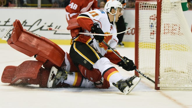 Calgary Flames center Mikael Backlund (11) scores past Detroit Red Wings goalie Jimmy Howard (35) during the third period. The Flames defeated the Red Wings 3-2.