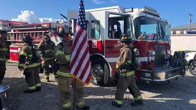 In honor of those who lost their lives during 9/11 Surf City Fire Department prepare to march across the Surf City Bridge in full gear.