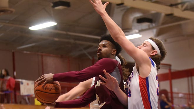 Licking Heights' Terence Harris takes a shot against defense from Licking Valley's Paul Kirk. The Hornets defeated the Panthers 61-44 on Friday, Feb. 10, 2017.