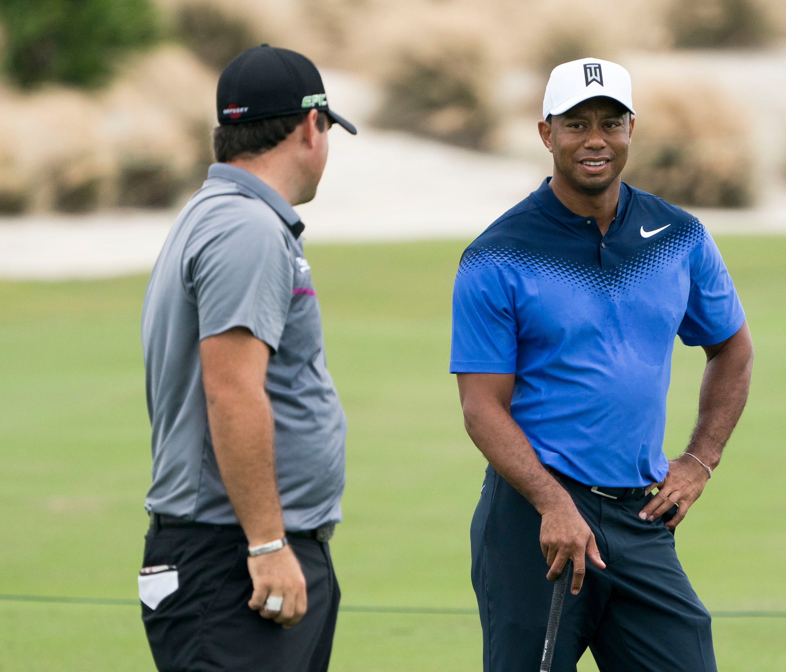 Tiger Woods (right) talks to Patrick Reed (left) on the fourth hole during Monday's practice round of the Hero World Challenge golf tournament at Albany in the Bahamas on Nov. 27.