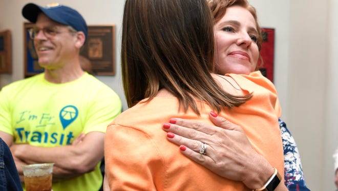 Transit supporter Kelly Brockman gets a hug at a Transit for Nashville election watch party at the Adventure Science Center on Tuesday, May 1, 2018, in Nashville.