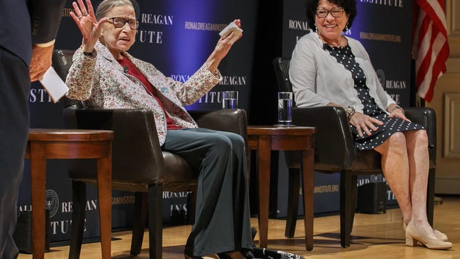 FILE - In this Sept. 25, 2019 file photo, Supreme Court Justice Ruth Bader Ginsburg, left, holds up her hands as she and Supreme Court Justice Sonia Sotomayor arrive to applause for a panel discussion celebrating Sandra Day O'Connor, the first woman to be a Supreme Court Justice, at the Library of Congress in Washington. (AP Photo/Jacquelyn Martin)