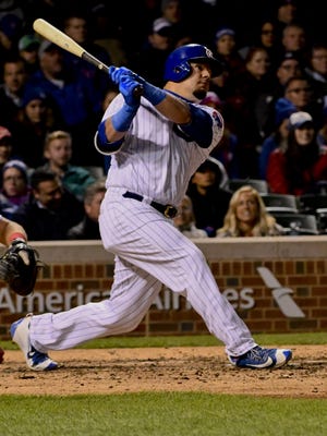Chicago Cubs left fielder Kyle Schwarber (12) watches his three-run home run in the fourth inning against the Philadelphia Phillies at Wrigley Field on May 2.