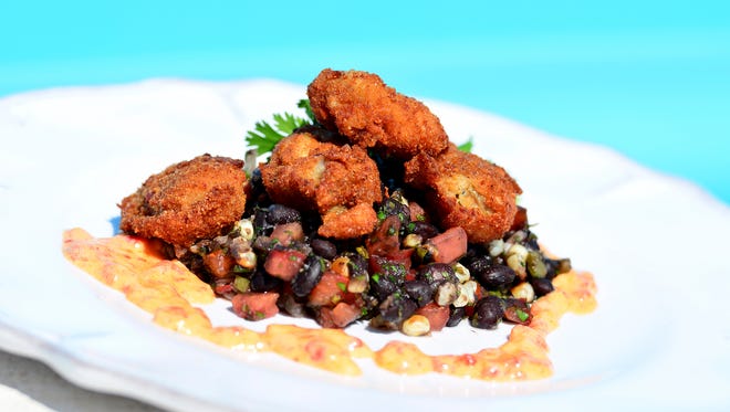 Applewood Smoked Bacon Crumbed Oysters on Fire Roasted Corn with Fiesta Black Beans,  Pepper Jack and Roasted Red Pepper Sauce, courtesy of Chef Gus Silivos. 