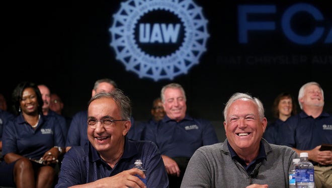 Fiat Chrysler CEO Sergio Marchionne, left, speaks to the media with UAW President Dennis Williams, during an event to mark the ceremonial beginning of its contract talks at the UAW-Chrysler National Training Center in Detroit on July 14, 2015.