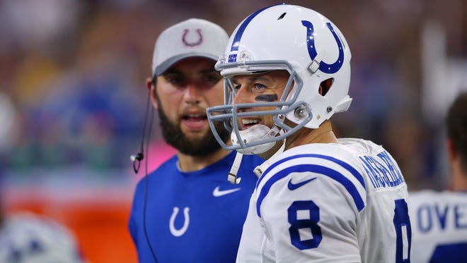 Indianapolis Colts quarterback Matt Hasselbeck (8) smiles after coming to the sideline with quarterback Andrew Luck (12) watching in the background during the second half of an NFL football game Thursday, Oct. 8, 2015, at NRG Stadium in Houston, Texas.