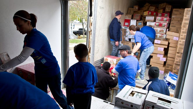 Volunteers unload a large load of donated food. Volunteers spend time at Lunch Break, a food pantry and soup kitchen that helps those in need throughout New Jersey. The volunteers came out for Make A Difference Day, the nation's largest day of community service.Red Bank, NJSaturday, October 24, 2015@dhoodhood