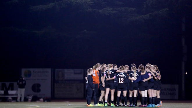 Silverton players gather on the field after the Silverton vs. Corvallis girl's soccer Mid-Willamette Conference championship game at Corvallis High School on Tuesday, Oct. 27, 2015. Corvallis won the championship 2-1.