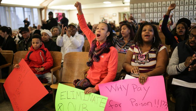 Flint resident Janay Young (left) and Erica Riley cheer on as Flint City councilman Eric Mays makes a comment during a meeting in the Council Chambers at Flint City Hall on Wednesday February 3, 2016 where the city's administrator and Chief Financial Officer explained the city's financial position to water and sewer rates.
