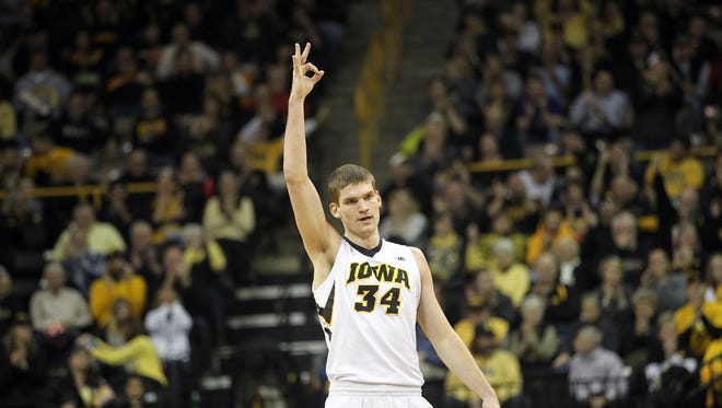 Iowa's Adam Woodbury celebrates a 3-pointer from Peter Jok during the Hawkeyes' game against Penn State at Carver-Hawkeye Arena on Wednesday, Feb. 3, 2016.