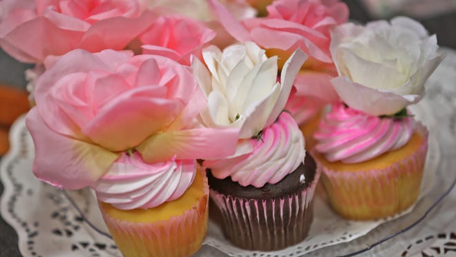 Cupcakes decorated with silk flowers were a tasty and beautiful treat at the Mother's Day Tea at the Ronald McDonald House of Indiana inside Riley Children's Hospital, Sunday, May 10, 2015. A reader says that father's deserve the same credit as mother's when Father's Day arrives.