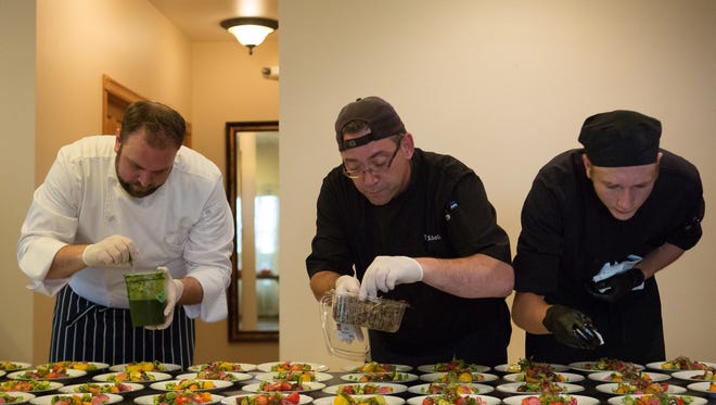 Chef Edward Gilbert, Tony Scholes and James Adams plate the salad course at Eat+Drink's Secret Supper at the Tapestry House Thursday, July 29, 2016.