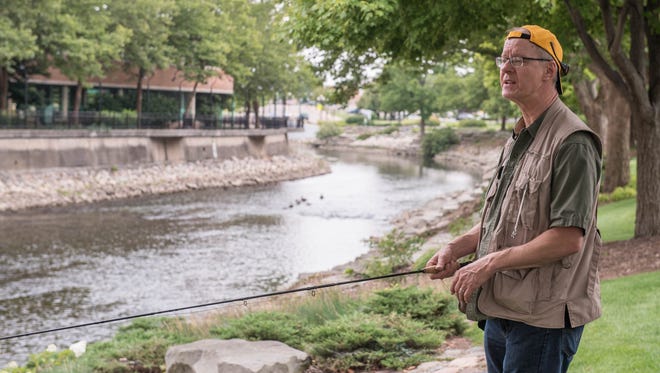 Paul Jakubiak assembles his fly-fishing rod before an event on the Battle Creek River to help people learn fly fishing and promote that the rivers in our area are a valuable asset.