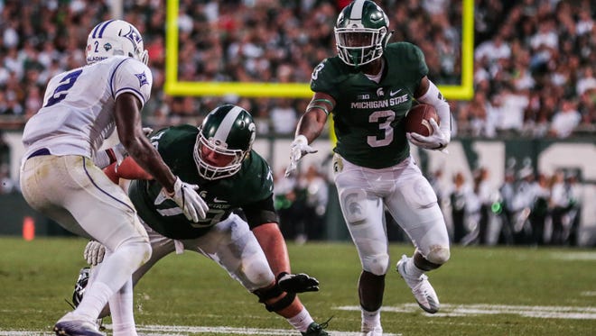 Michigan State's LJ Scott runs the ball against Furman during MSU's home opener game at Spartan Stadium in East Lansing on Friday, September 2, 2016.