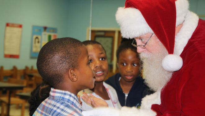Santa visits with the children at the Gifford Youth Achievement Center before passing out presents.