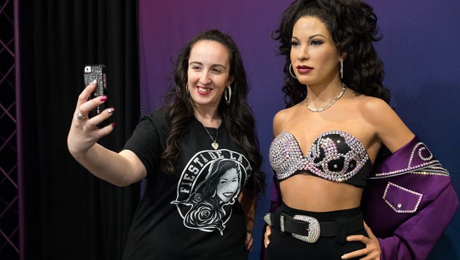 Rachel Casey of Boston MA, takes a selfie with the Madame Tussauds Hollywood wax Selena figure in the Art Museum of South Texas during Fiesta de le Flor on Friday, March 24, 2017.