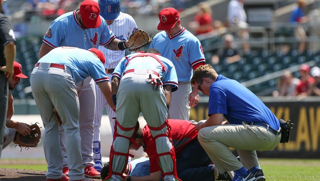 Trainers tend to Memphis Redbirds starting pitcher Daniel Poncedeleon, who was struck in the head by a ball on Tuesday, May 9, 2017, during a game against the Iowa Cubs in Des Moines, Iowa.