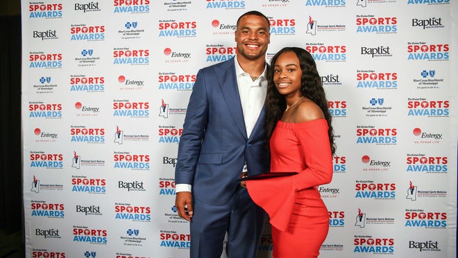 Girls' basketball player of the year Myah Taylor of Olive Branch High School with Dak Prescott.