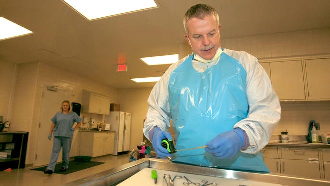 In this file photo, Larimer County Coroner and Medical Examiner Dr. James Wilkerson sets up to perform an autopsy at the McKee Medical Center morgue on May 26, 2017.
(Photo: Joel Blocker/For The Coloradoan)