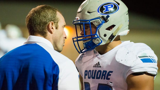 Poudre High School running back JT Erickson (32) gets scolded by a coach after incurring a penalty during a game against Rocky Mountain High School on Friday, Sept. 22, 2017, at French Field in Fort Collins, Colo.