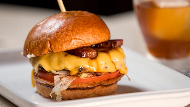 The "Homecoming" burger is topped with thick-cut, root beer glazed bacon and smoked gouda cheese, served at Burger Study, an upscale restaurant and bar attached to Circle Centre Mall, Indianapolis, seen Friday, Sept. 22, 2017.