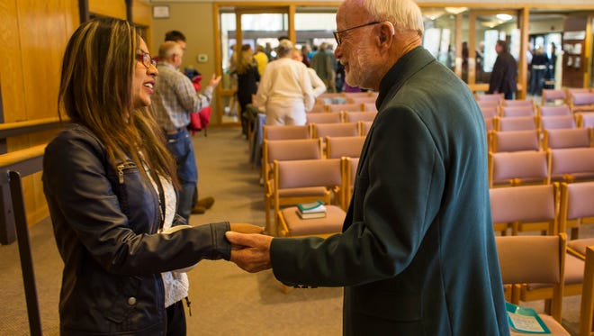 Longtime congregation member Ken Tharp greets Peruvian sanctuary seeker Ingrid Encalada Latorre after a service where she was introduced to the congregants, Sunday morning, Oct. 22, 2017, during a worship service at Foothills Unitarian Church in Fort Collins, Colo.