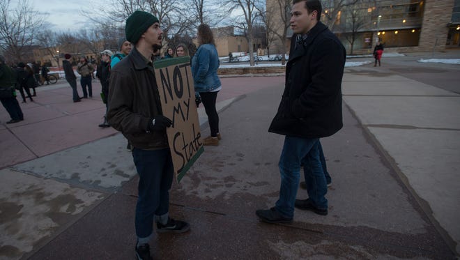 Demonstrator Brennan Dyhouser, left, engages in dialog with another man who requested to stay anonymous on Friday, Feb 2, 2018, at the Lory Student Center on campus at Colorado State University in Fort Collins, Colo.